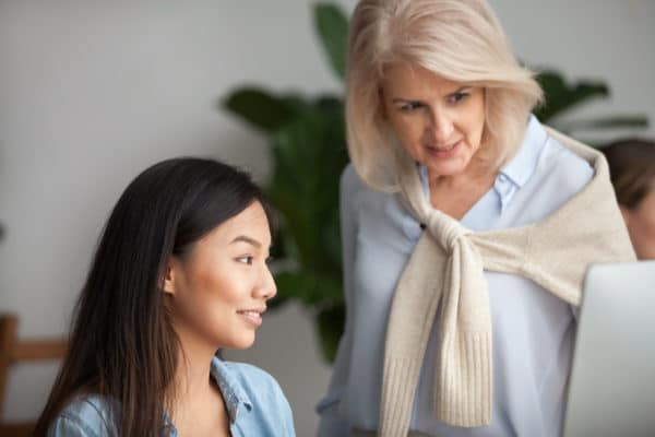 2 business women looking at a computer screen